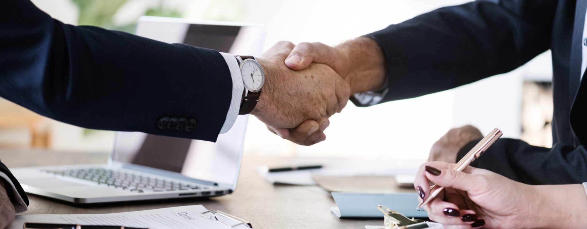 Business people shaking hands together